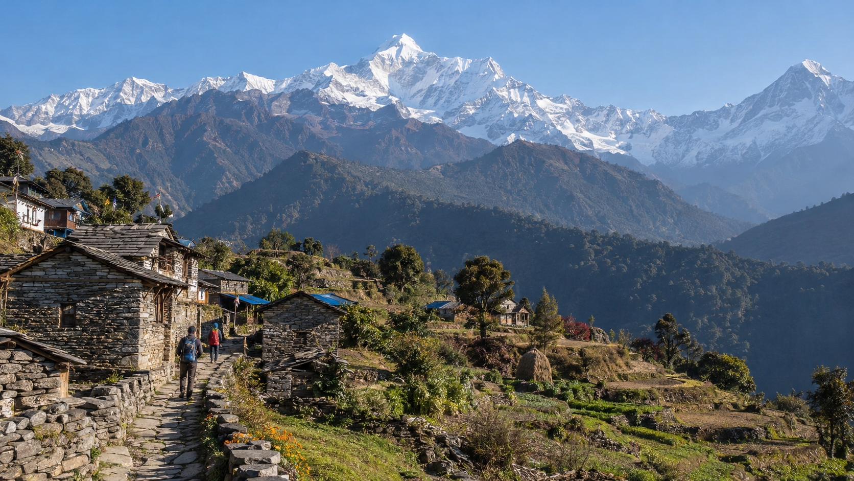 Terraced hills and stone village houses beneath snow-covered Annapurna peaks in Nepal